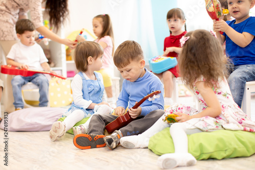 Group of kids playing musical toys. Early musical education in kindergarten or primary school