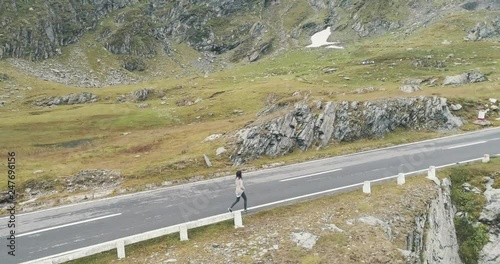 Young girl walking on a mountain road - 03 photo