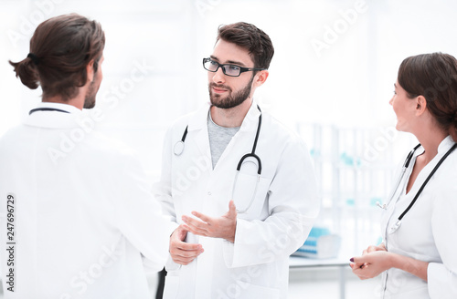 Medical staff discuss in a modern hospital room