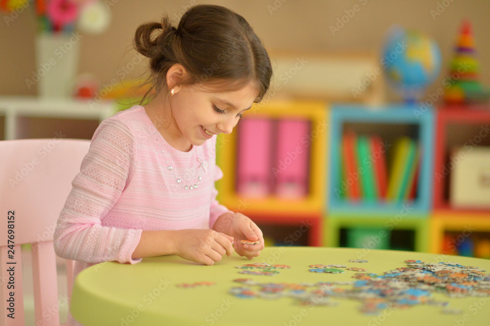 Portrait of girl collecting puzzles at home Portrait of girl collecting puzzles at home