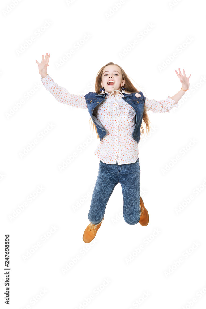 Happy little girl in jeans jumping on white background Happy little girl in jeans jumping on white background