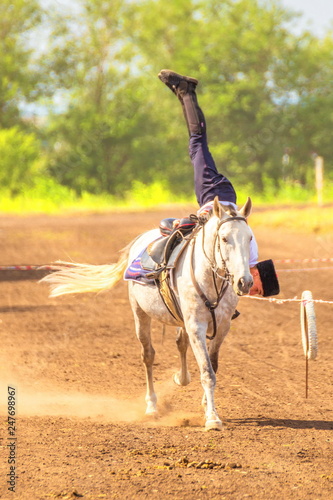 Russia, Samara, July, 2018: The Cossack rides a horse and performs tricks. photo