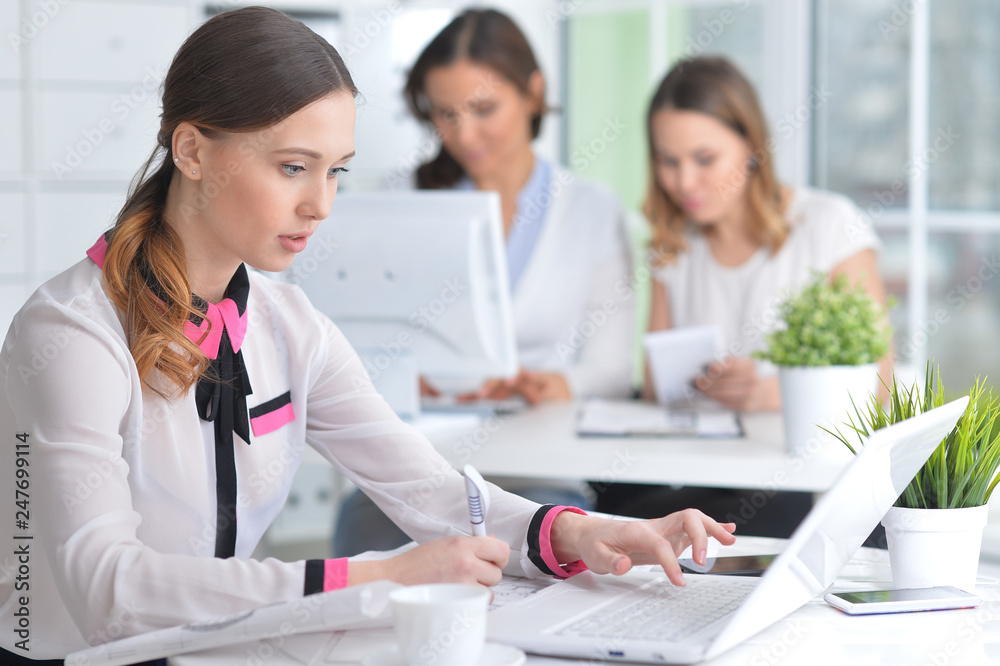 Portrait of young women working in modern office