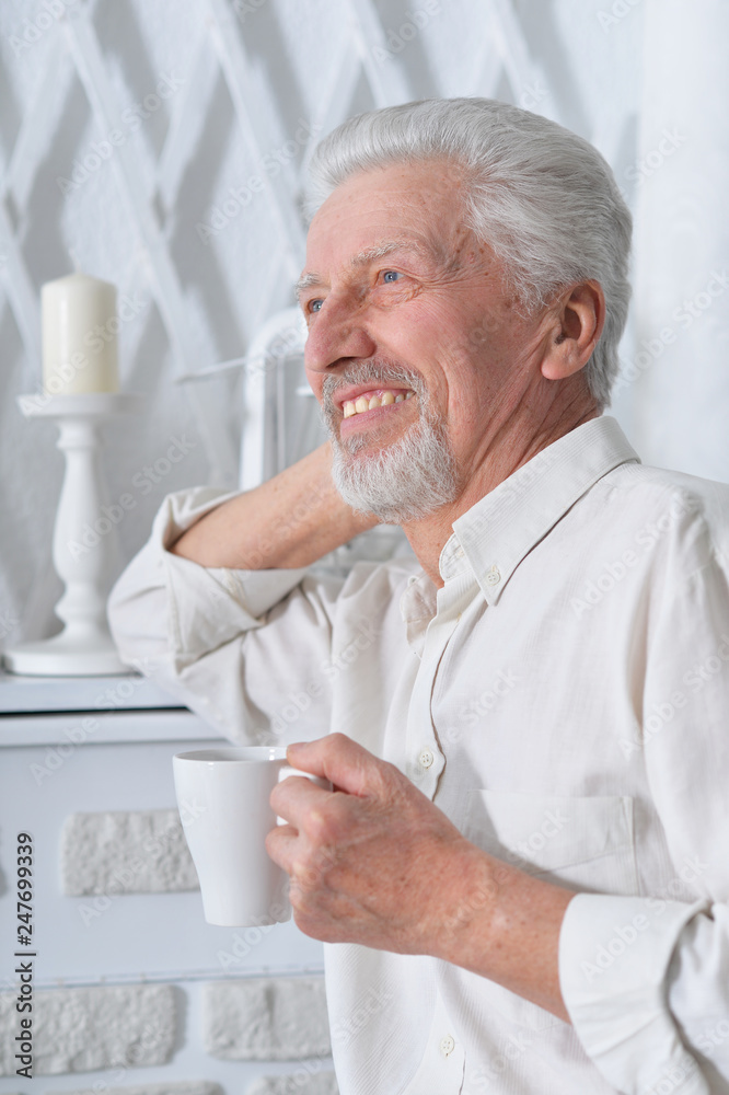 Portrait of smiling senior man drinking tea Portrait of smiling senior man drinking tea