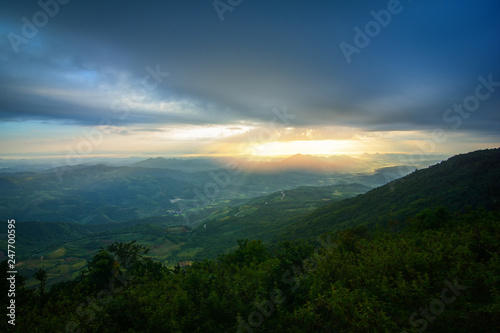 Landscape sun rise on hill mountain with yellow sky and rising sunshine in the morning © Bigc Studio