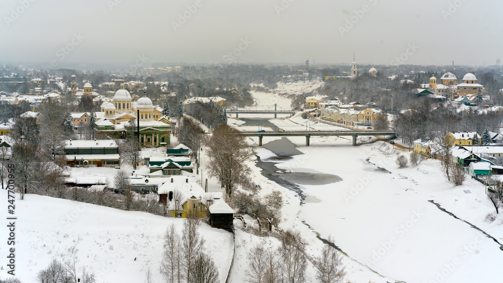 A winter view of the small old town in Russia with medieval churches, monastery, old-fashione houses,