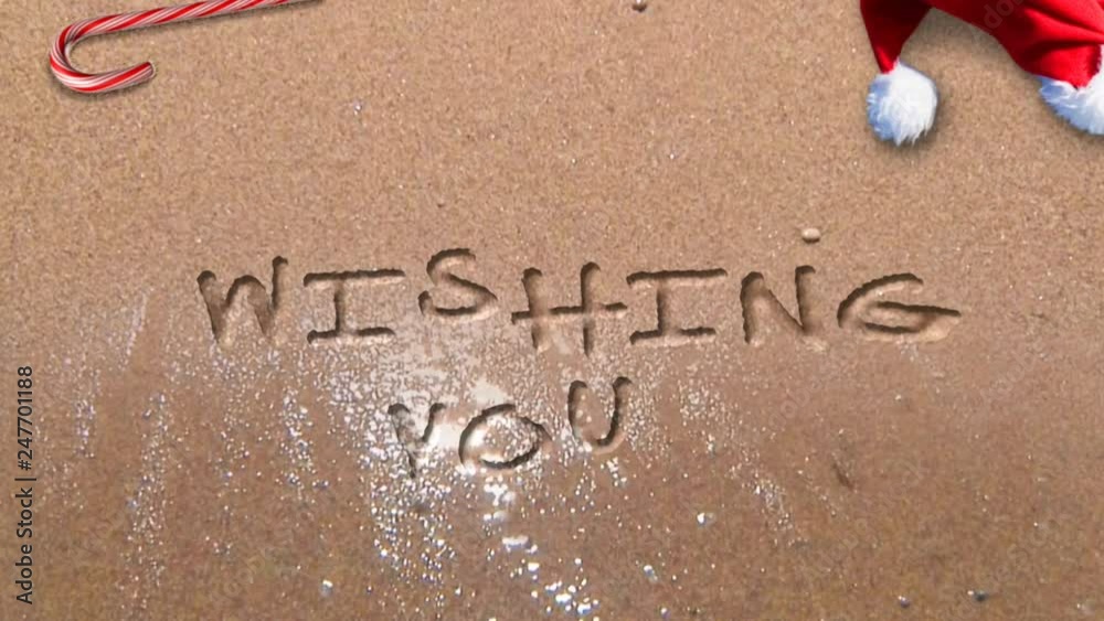 Merry Christmas Happy New Year Beach 4K Loop waves washing up on a sandy beach and leaving behind a Merry Christmas Happy New Year message written in the sand in a loop