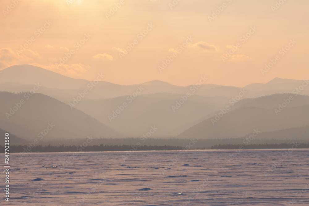 panorama winter mountain,misty hills mountain tops in pink dawn