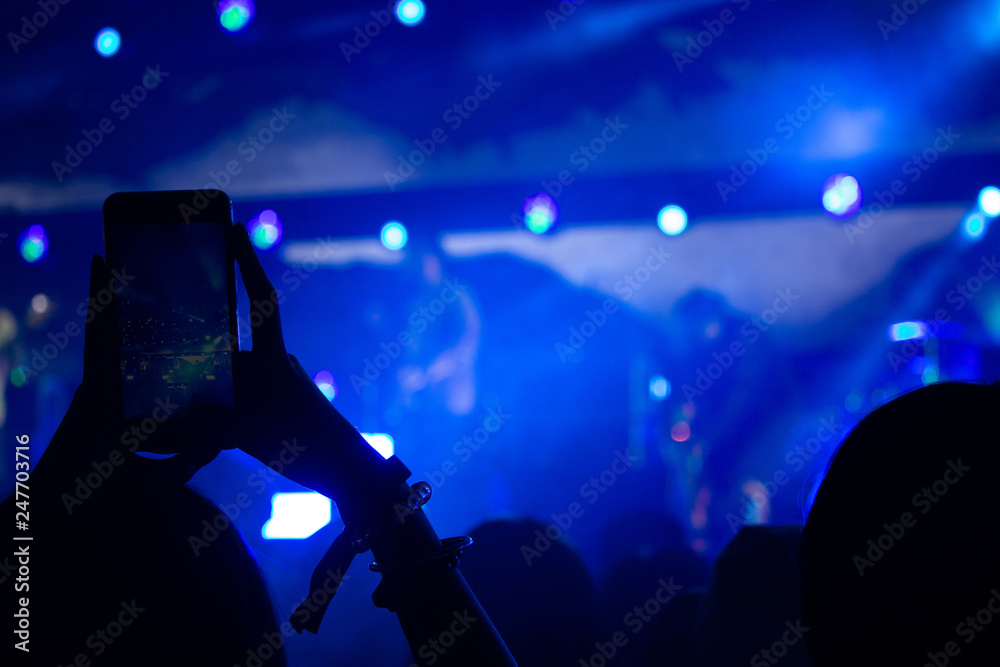 Hand with a smartphone records live music festival, Taking photo of concert stage, live concert, music festival