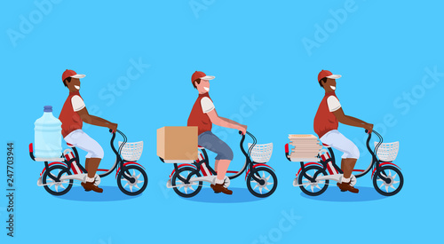 mix race couriers men cycling bicycle carrying parcel box water bottle pizza express delivery concept guys in uniform riding bike male cartoon characters full length horizontal flat