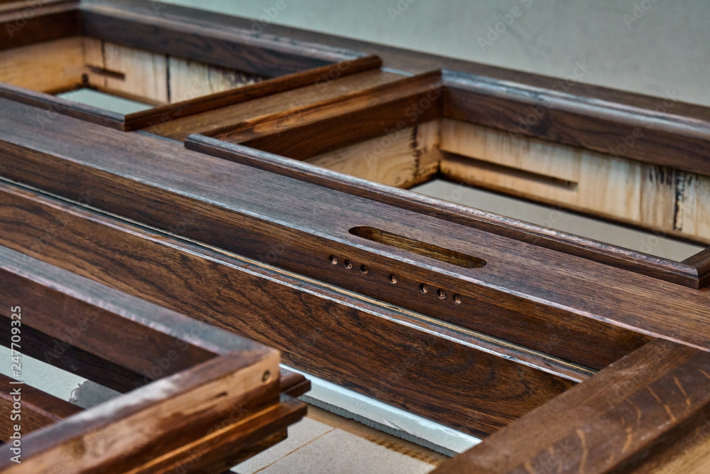 Wood door manufacturing process. Door frame, painted in dark color. Furniture manufacture. Wood door manufacturing process. Door frame, painted in dark color. Furniture manufacture.