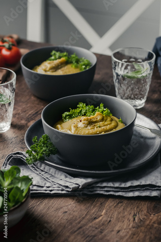 Split Pea Soup with Vegetables on a wooden background, selected focus