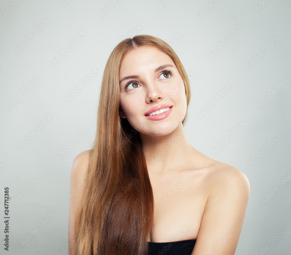 Smiling woman looking up . Cute girl with natural healthy hair and clear skin Smiling woman looking up . Cute girl with natural healthy hair and clear skin