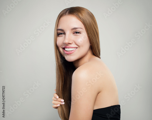 Happy girl with long healthy hair and perfect skin on white background, portrait