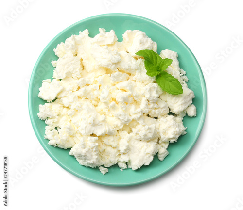 cottage cheese in blue bowl isolated on white background top view