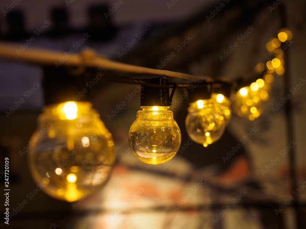 included yellow lights on the wire one by one with blurred foreground and background