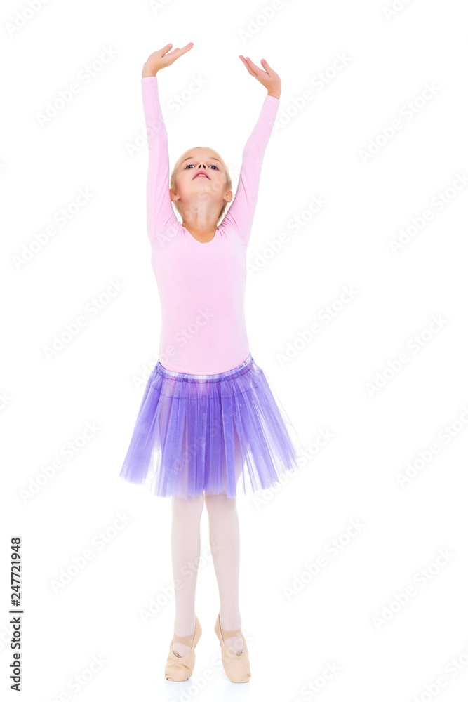 Little girl ballerina performs dance.