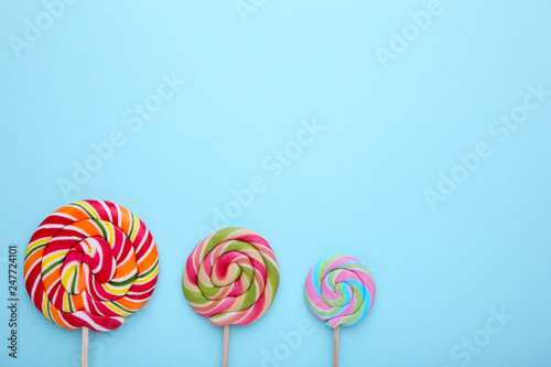 Colorful lollipops on blue background. sweet candy concept