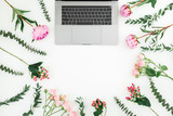Floral frame with laptop and pink flowers on white background. Top view. Flat lay.