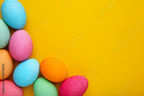 Colorful easter eggs on a yellow background