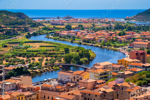 Sardinia, Italy - Panoramic view of the town of Bosa by the Temo river with Bosa Marina resort at the Mediterranean sea coast seen from Malaspina Castle hill - known also as Castle of Serravalle