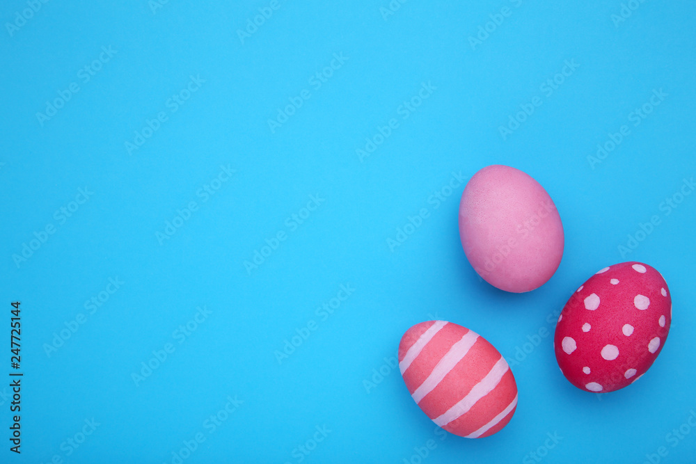 Three easter eggs on a blue background