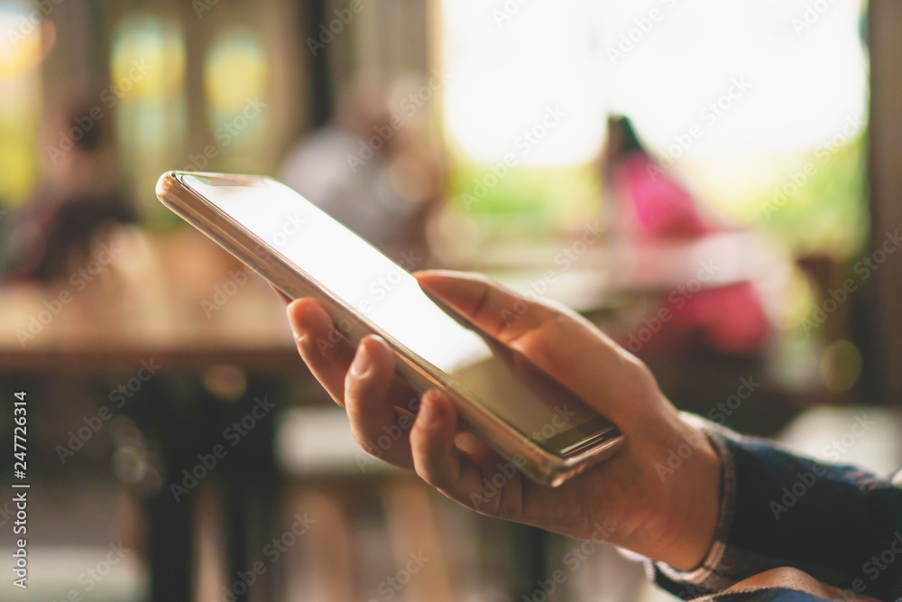 Woman hand using smartphone in cafe shop background. Business, financial, trade stock maket. Woman hand using smartphone in cafe shop background. Business, financial, trade stock maket.