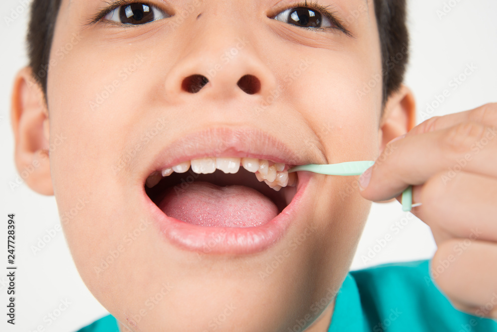 Little boy using dental floss to clean tooth Little boy using dental floss to clean tooth