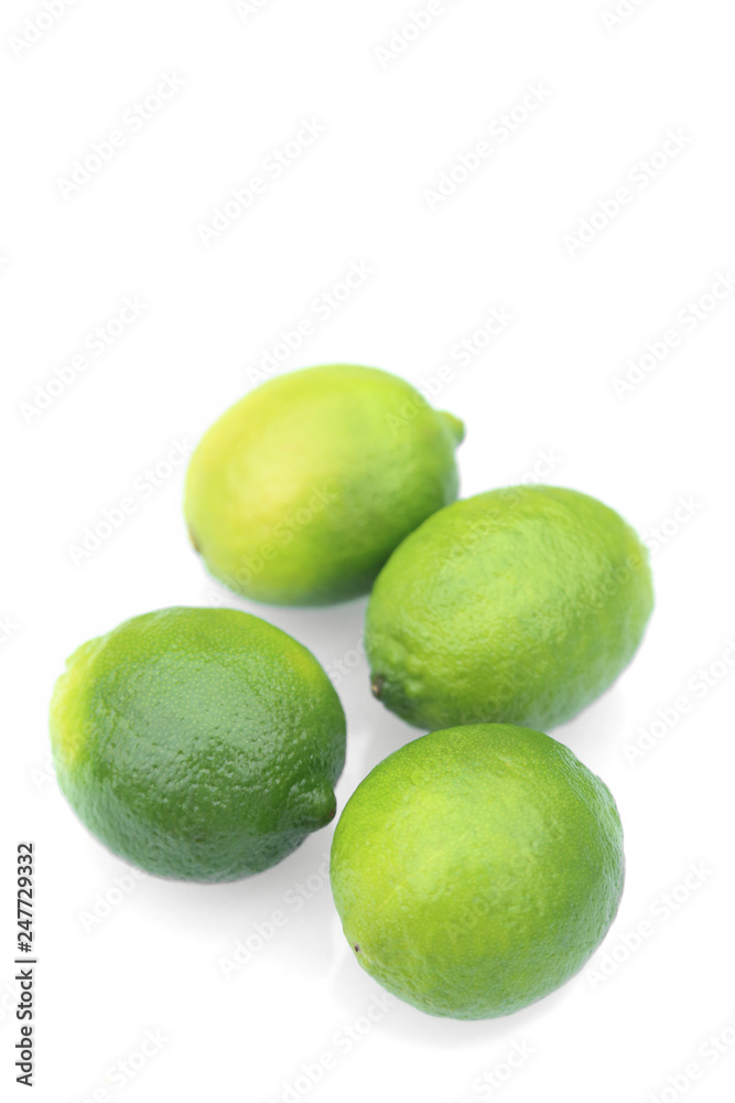 Fresh green limes, tropical fruits on white background. Fresh green limes, tropical fruits on white background.