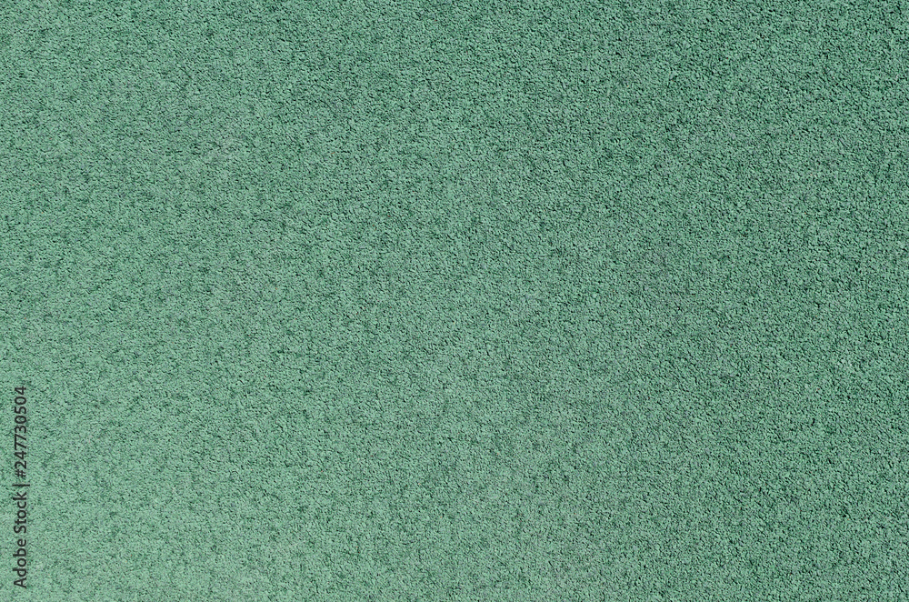 Fototapeta premium Green rubber covering for sports and playgrounds.