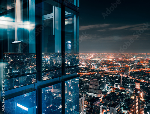 Glass window with glowing crowded city Fototapet