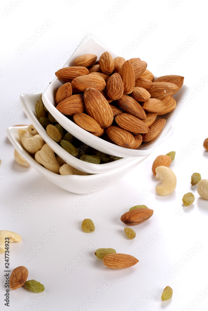 ssorted nuts on white, dry fruits, mix nuts, almond, cashew, raisin ssorted nuts on white, dry fruits, mix nuts, almond, cashew, raisin