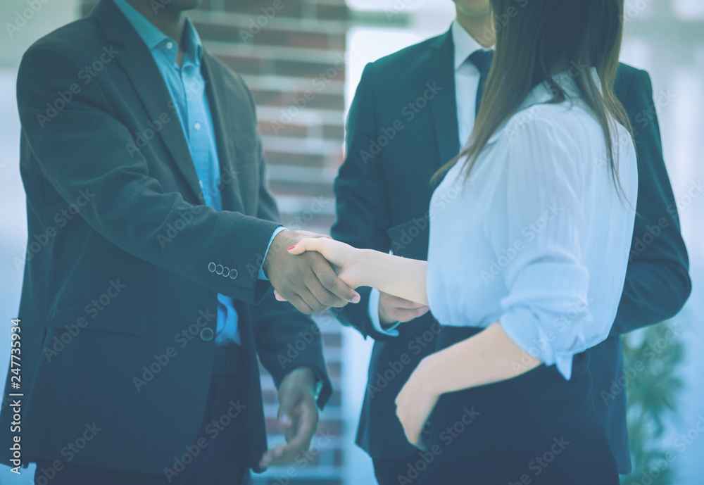 closeup .business handshake financial partners on the background of the office