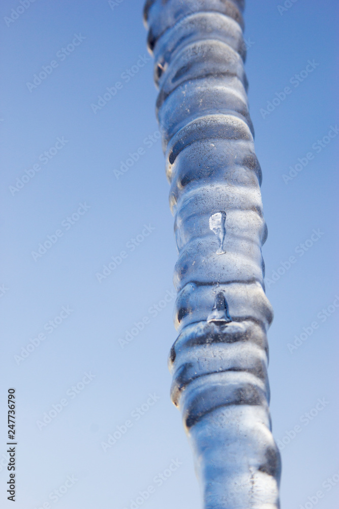 long icicle against blue sky
