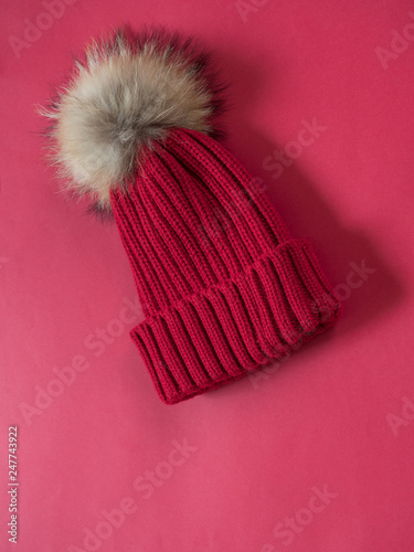 Red wool hat on red background