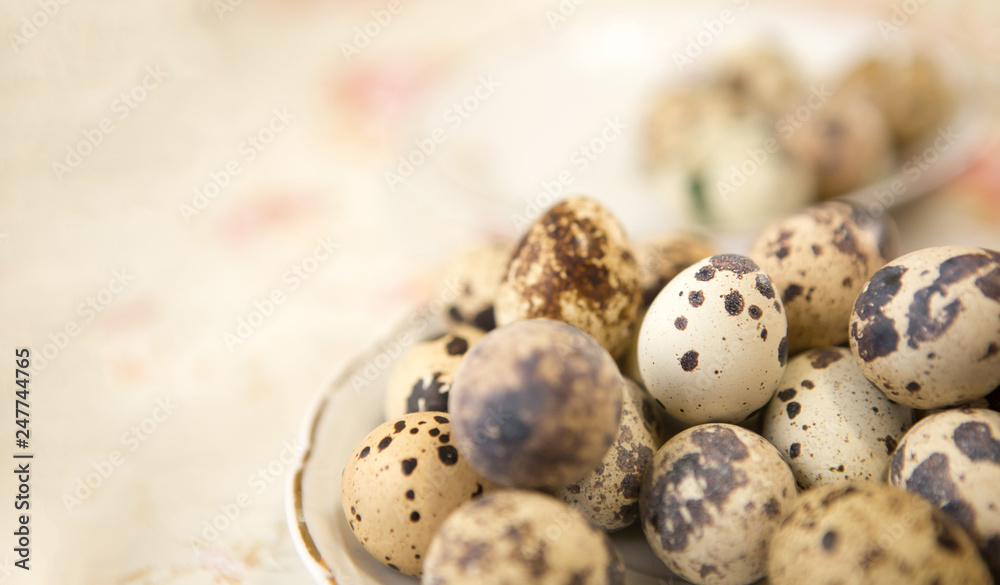 A lot of eggs of quail in an old plate on the kitchen table. A lot of eggs of quail in an old plate on the kitchen table.