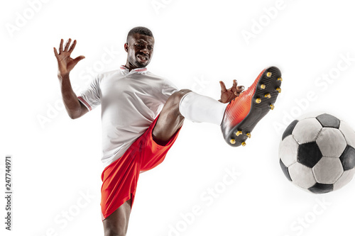 Fototapeta Naklejka Na Ścianę i Meble -  Professional african american football soccer player in motion isolated on white studio background. Fit jumping man in action, jump, movement at game.