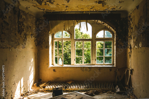 an old room with destroyed windows in an abandoned place