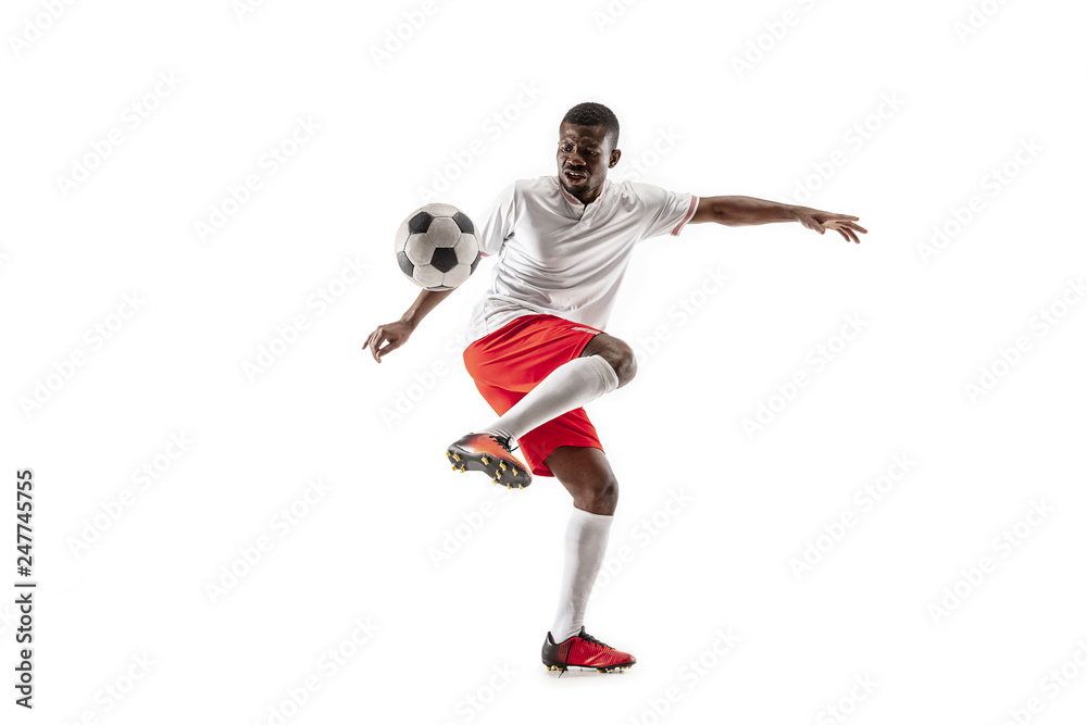 Professional african american football soccer player in motion isolated on white studio background. Fit jumping man in action, jump, movement at game.