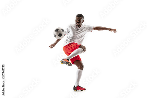 Professional african american football soccer player in motion isolated on white studio background. Fit jumping man in action, jump, movement at game.