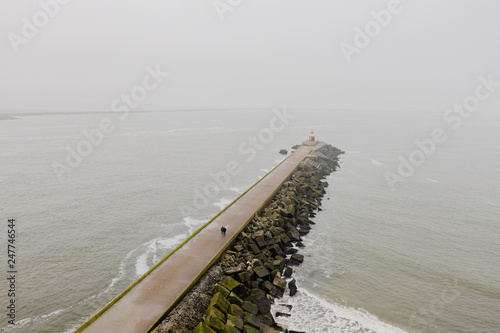 A pier leading into the North Sea in the Netherlands, seen from a higher perspective.
