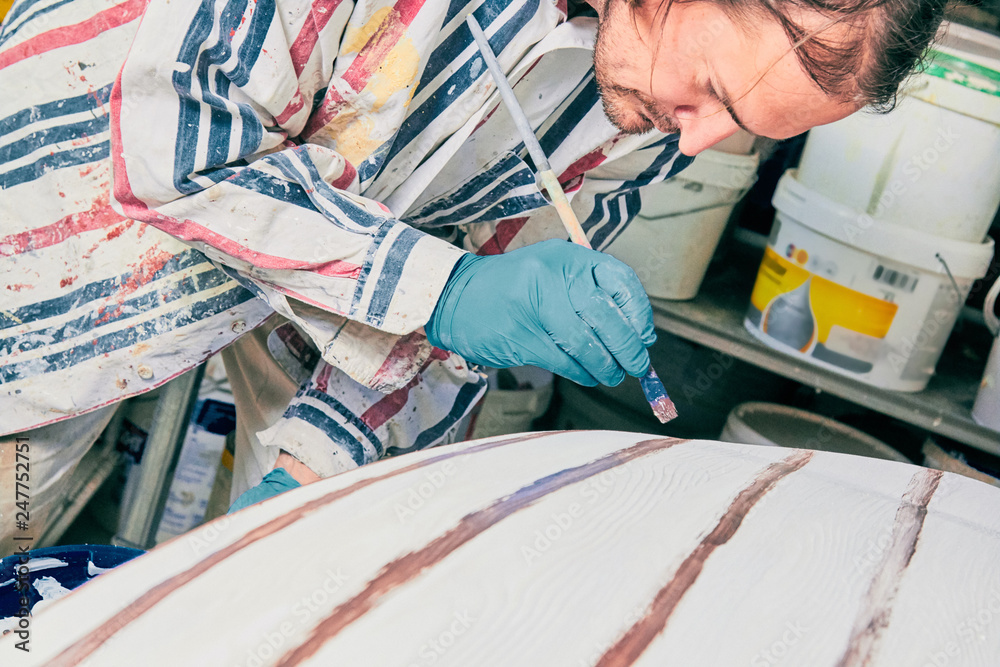 Artist using paint brush for making artificial wood texture. Artist using paint brush for making artificial wood texture.