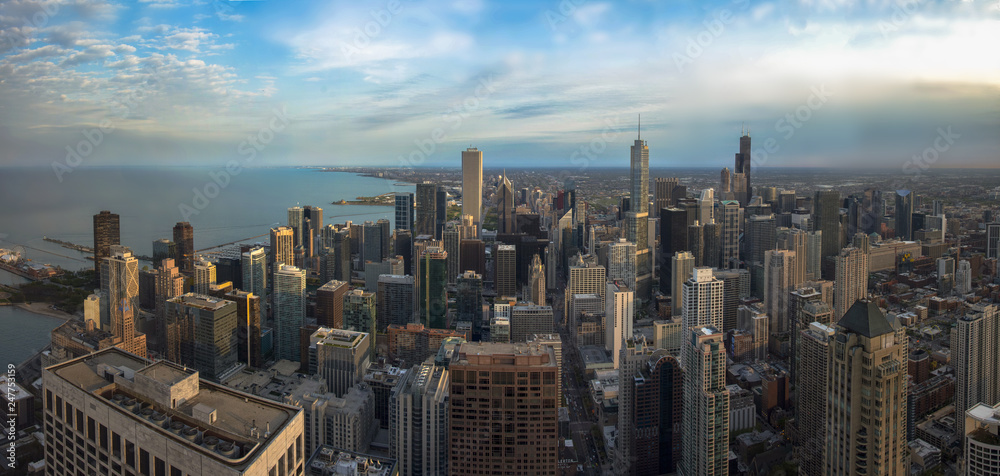 Chicago skyline panorama aerial view with skyscrapers and cloudy sky at sunset.