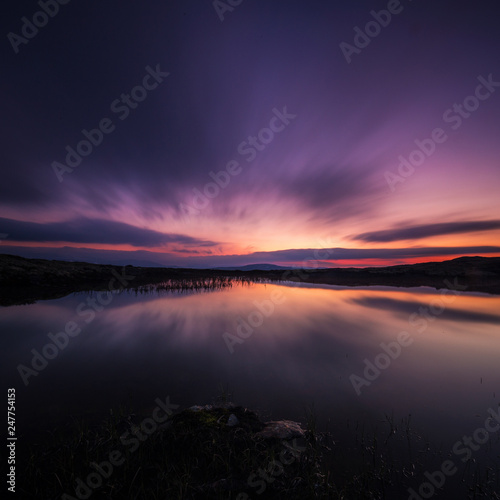 Fotografie, Obraz Long exposure on night sky and small lake in area of Nordgruvefeltet in middle Norway