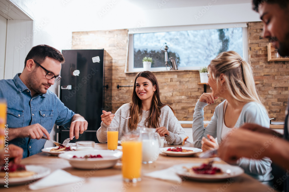 Low angle image of friends enjoying at casual food party on winter day. Low angle image of friends enjoying at casual food party on winter day.