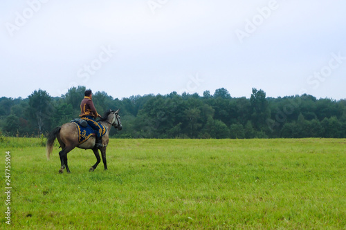 man riding horse in a field