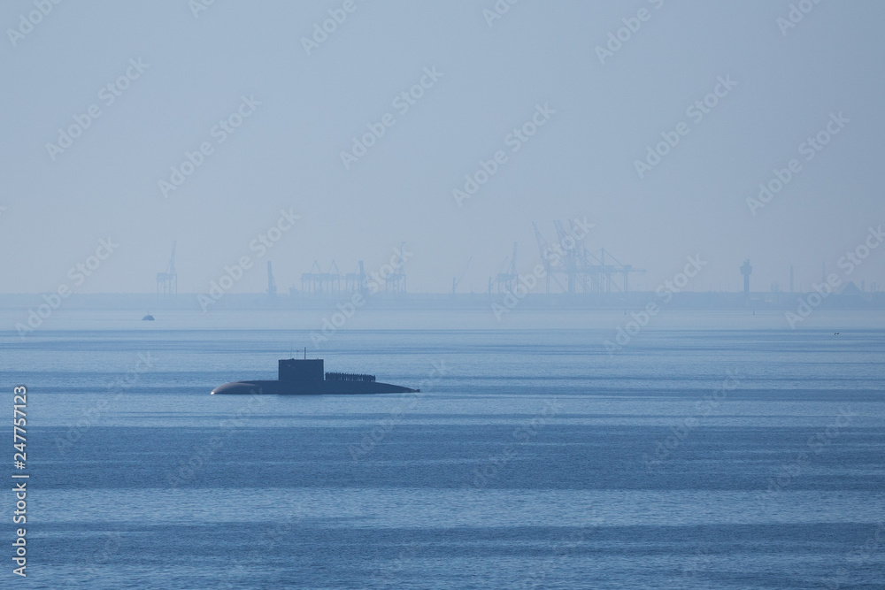 Distant silhouette of submarine ship and the crew.