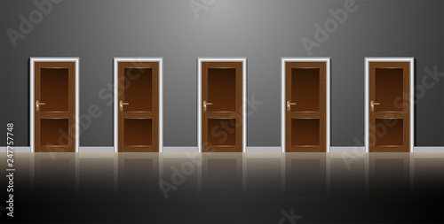 A row of five wooden doors on a gray wall. Dark corridor and reflection in the floor. For an article about choices or options.