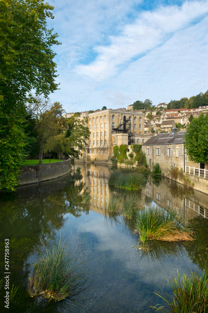 Picturesque homes climb the hill above the River Avon in autumn sunshine, Bradford on Avon, Wiltshire, UK