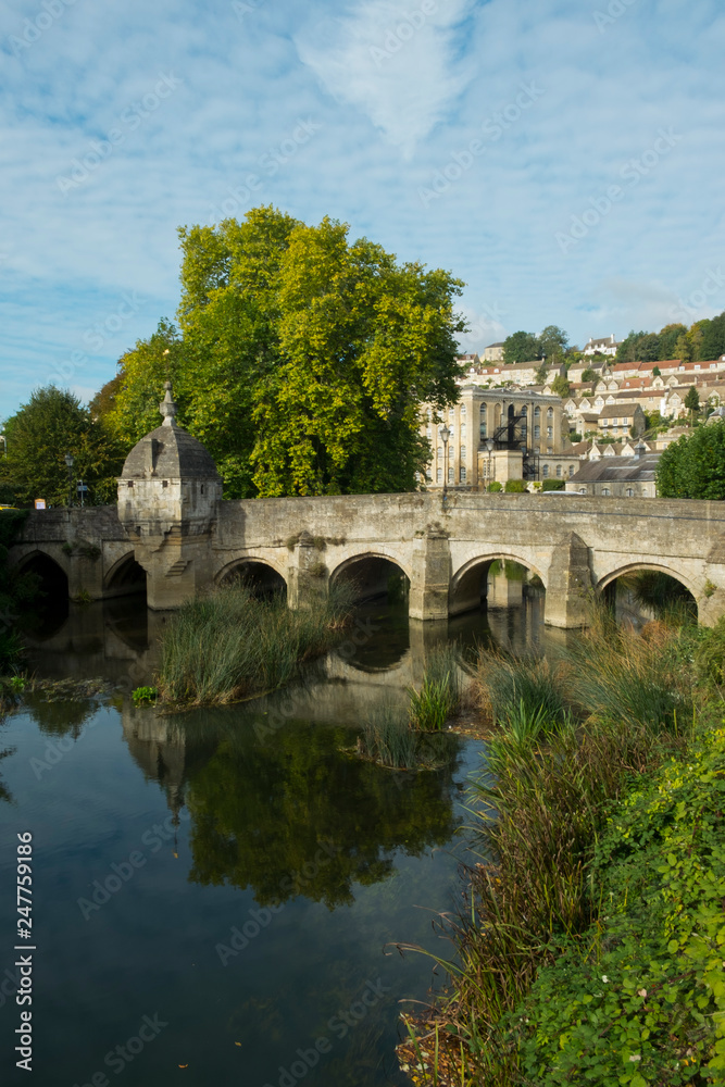 The well known ancient bridge over the River Avon with its one-time chapel and later lock-up in autumn sunshine, Bradford on Avon, Wiltshire, UK